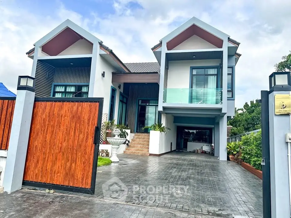 Stunning modern two-story house with spacious driveway and elegant architectural design.
