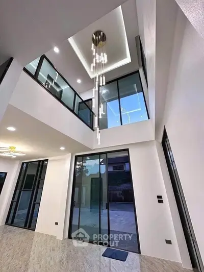 Stunning modern interior with high ceilings and elegant chandelier in luxury home