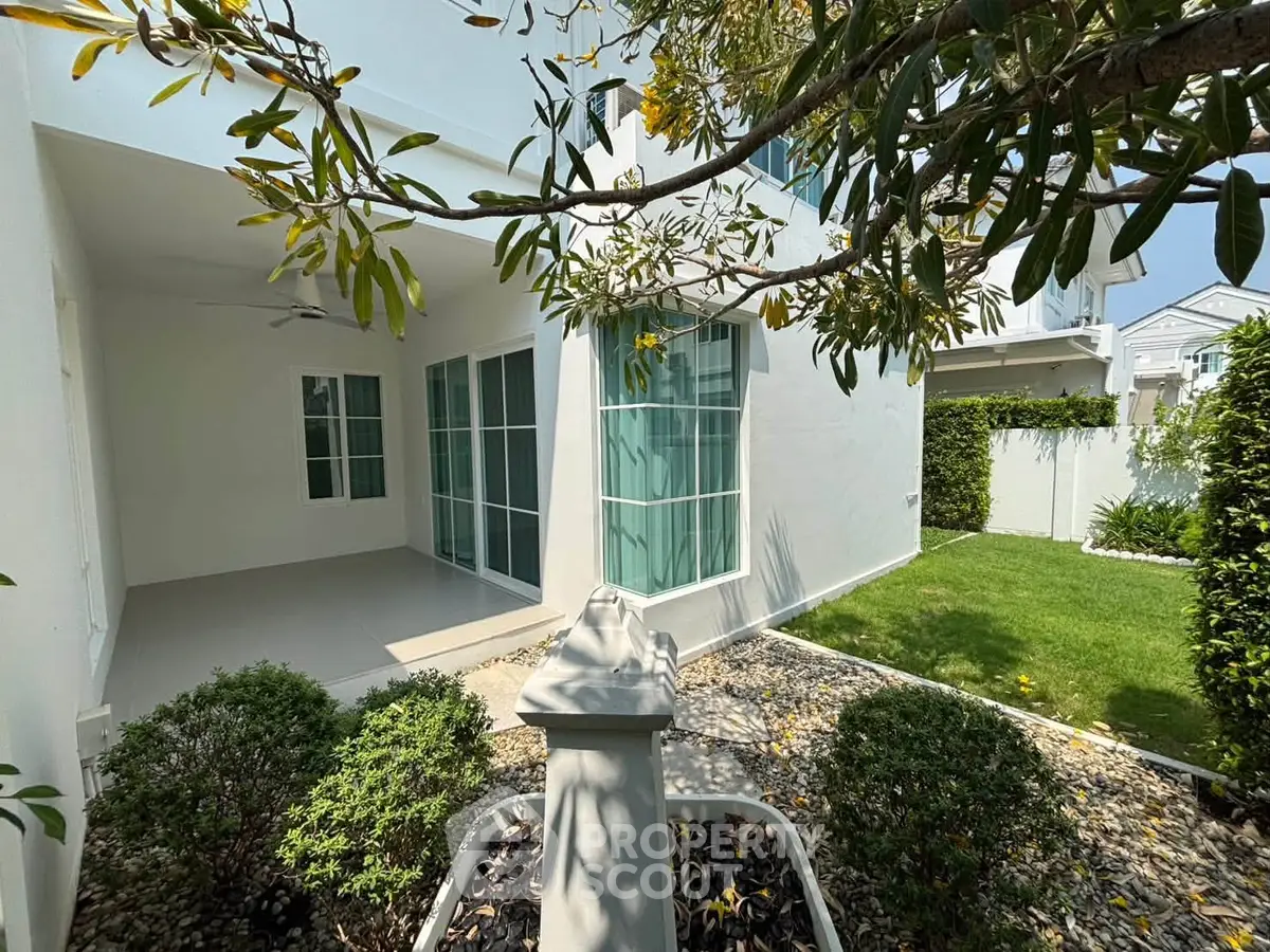 Charming modern home with lush garden and spacious patio, perfect for outdoor relaxation and entertaining.