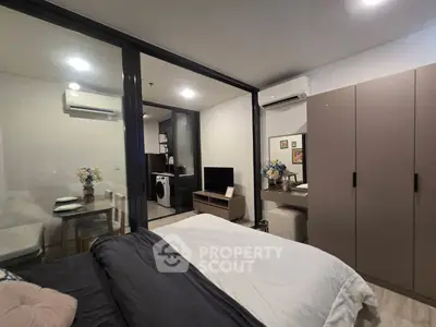 Modern studio apartment with open layout, featuring a cozy bedroom, dining area, and compact kitchen.