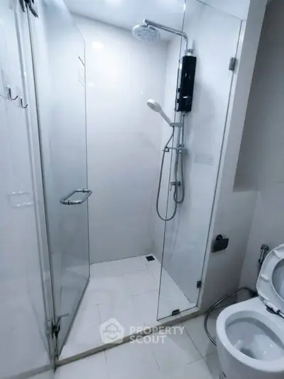 Modern bathroom with glass shower enclosure and sleek fixtures