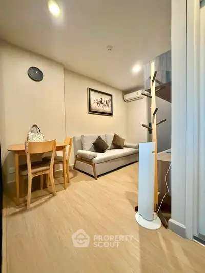 Cozy living room with modern decor, wooden flooring, and stylish furniture in a contemporary apartment.