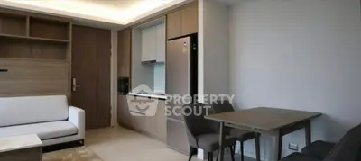 Modern apartment interior with sleek kitchen and cozy living area, perfect for urban living.