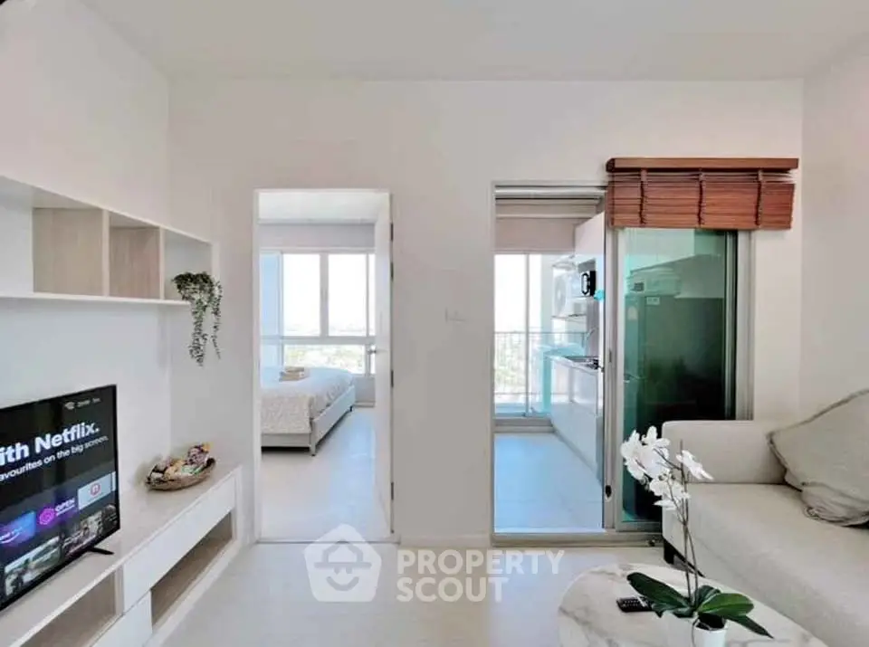 Modern apartment interior with cozy living room and open kitchen layout, featuring natural light and stylish decor.
