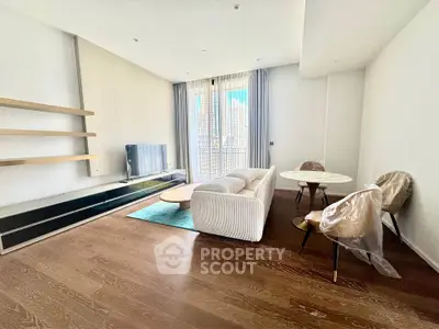 Spacious modern living room with elegant furniture and large windows for natural light.