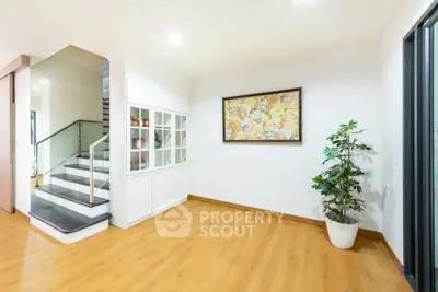 Spacious modern interior with elegant staircase and wooden flooring