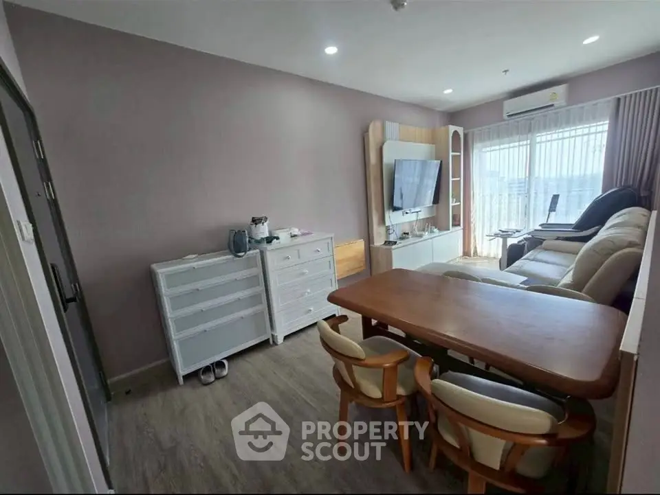 Cozy living room with modern furniture and natural light, perfect for relaxation and entertainment.