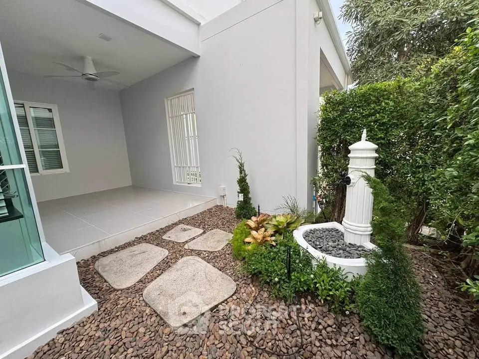 Charming garden with elegant stone path and decorative fountain in modern home exterior