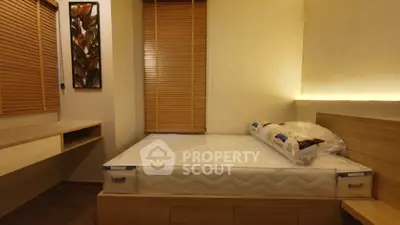 Cozy bedroom with modern design and natural light, featuring a comfortable bed and stylish decor.