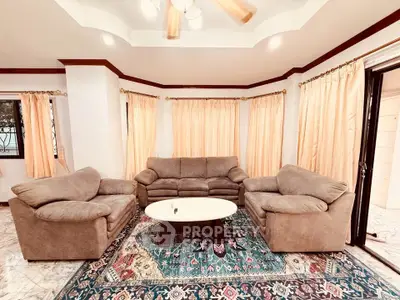 Spacious living room with cozy sofas and elegant curtains, perfect for relaxation and entertaining.