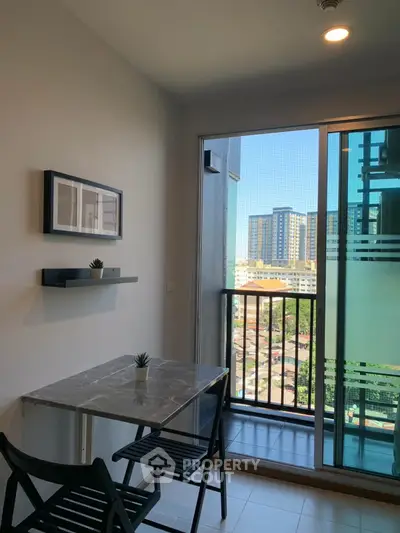 Modern apartment with balcony and city view, featuring sleek dining area and natural light.