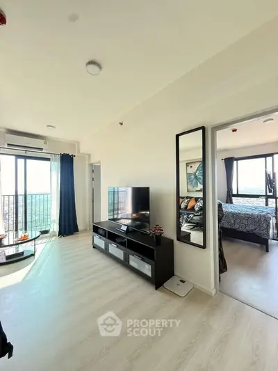 Modern living room with natural light and balcony view in a stylish apartment