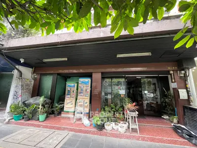 Charming street-level commercial property with lush greenery and inviting entrance.