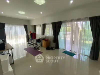 Spacious living room with large windows and modern decor