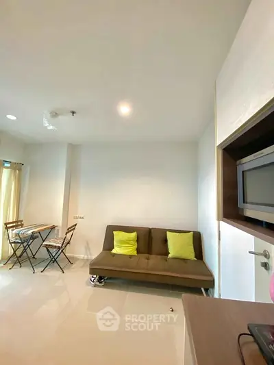 Modern living room with cozy sofa and dining area in bright apartment