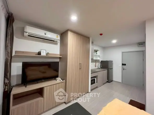Modern studio apartment with sleek kitchen and cozy living area