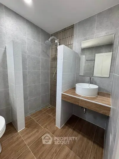 Modern bathroom with sleek design, featuring a walk-in shower and stylish vanity.