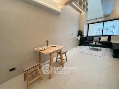 Modern minimalist living room with cozy seating and dining area