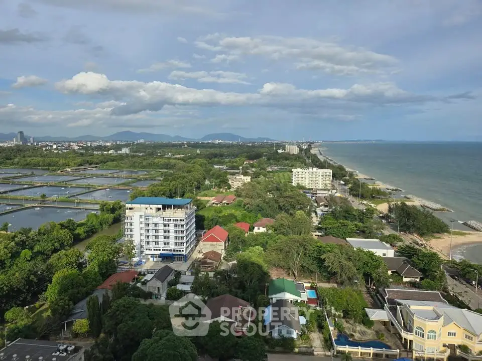 Stunning coastal view from high-rise building overlooking lush greenery and ocean horizon.