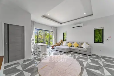 Spacious modern living room with elegant decor and large windows offering lush garden views.