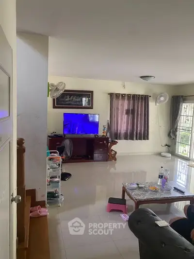 Spacious living room with modern decor and entertainment setup