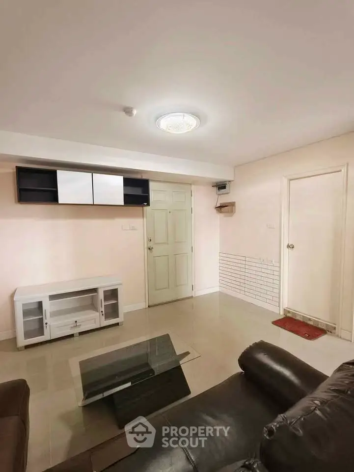 Spacious living room with modern furniture and sleek design in a contemporary apartment.