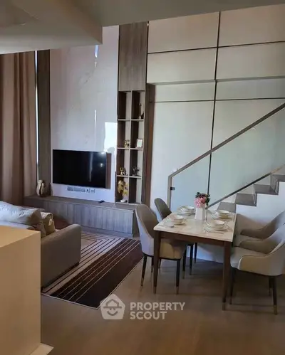 Modern living room with stylish dining area and sleek staircase in a contemporary apartment.