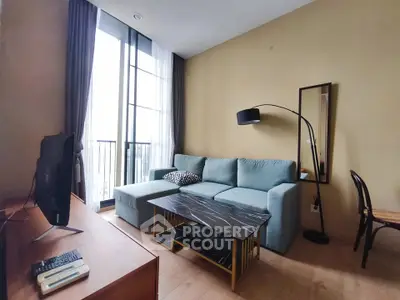 Modern living room with stylish furniture and large windows offering natural light.
