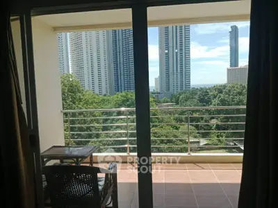 Spacious balcony with stunning cityscape view and lush greenery, perfect for relaxation and enjoying urban living.