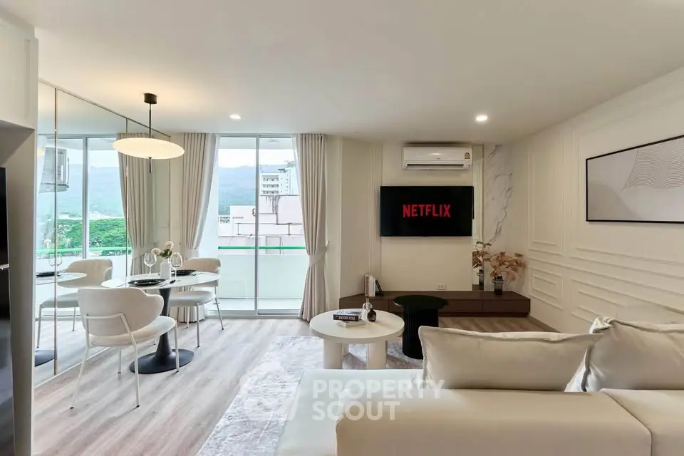 Modern living room with mountain view, stylish decor, and open layout in a luxury apartment.