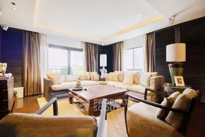 Luxurious living room with elegant furniture and large windows offering natural light.