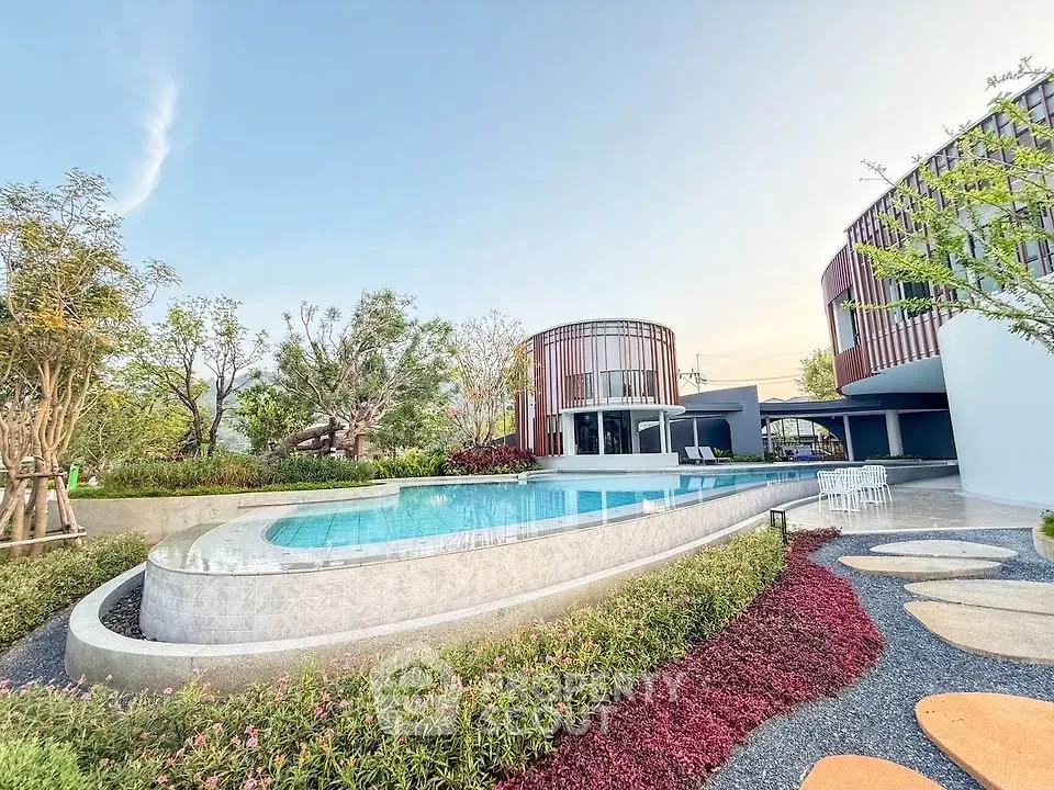 Luxurious modern building with stunning pool and lush garden landscape.