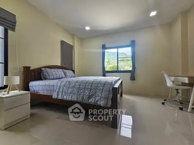 Spacious bedroom with natural light and modern furnishings, ideal for comfort and relaxation.