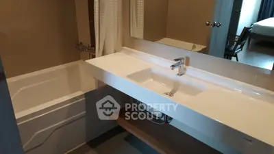 Modern bathroom with sleek sink and bathtub in contemporary apartment