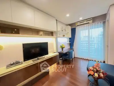 Modern living room with TV, wooden flooring, and large window with city view.