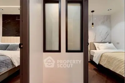 Modern bedroom with elegant design and cozy ambiance, featuring stylish lighting and luxurious bedding.