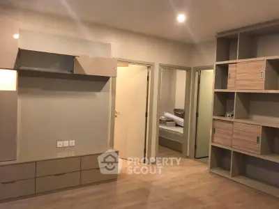 Spacious modern living room with built-in storage and sleek design.