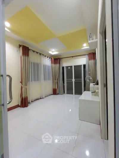 Spacious room with modern decor and large windows for natural light