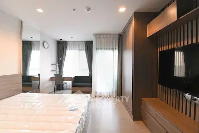 Modern bedroom with sleek design, large windows, and built-in storage solutions.