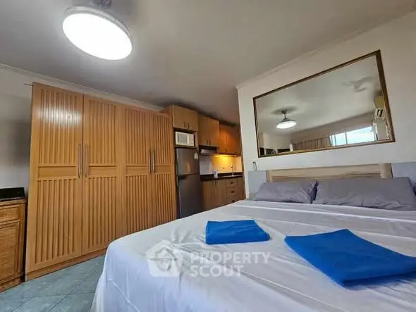 Cozy bedroom with modern kitchen amenities and ample storage space.