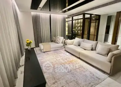 Luxurious modern living room with elegant decor and spacious seating area.