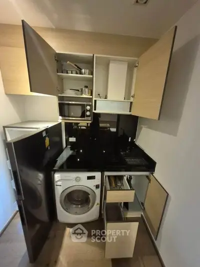 Compact kitchen with modern appliances and efficient storage solutions