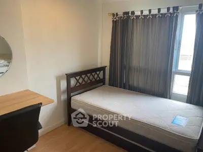 Cozy bedroom with single bed, desk, and window with curtains, perfect for a student or single professional.