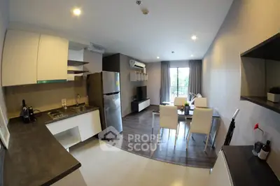 Modern open-plan kitchen and living room with sleek design and natural light.
