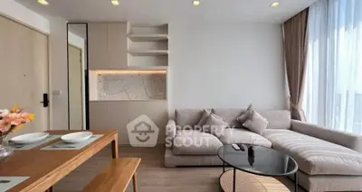 Modern living room with cozy sectional sofa and elegant dining area in a bright apartment.