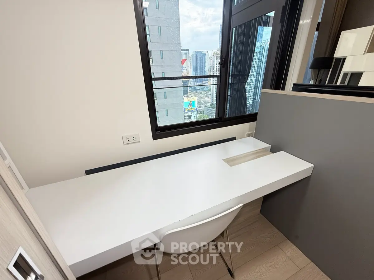 Modern study area with sleek desk and city view from window