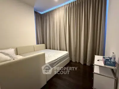 Cozy bedroom with elegant curtains and modern furniture, perfect for restful nights.