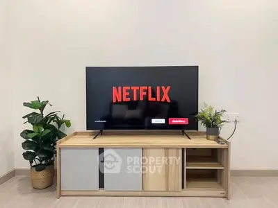 Modern living room with sleek TV stand and Netflix on screen, perfect for entertainment enthusiasts.