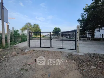 Spacious industrial property with secure gated entrance and ample outdoor space.