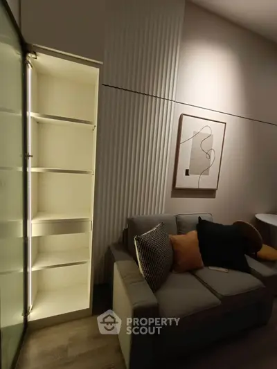 Modern living room with stylish sofa and illuminated shelving